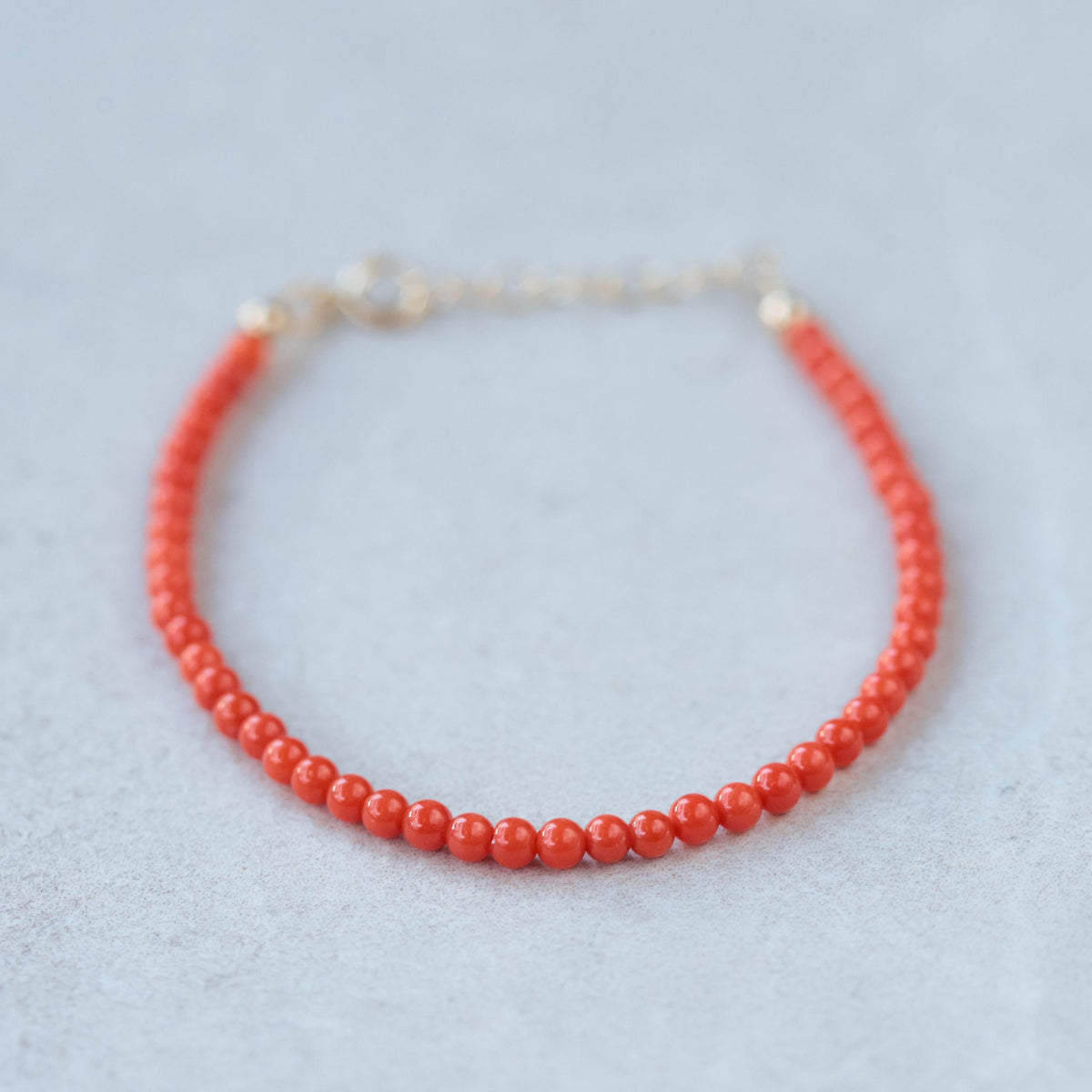 Italian Coral 3mm beads in 14K gold setting by Earthly Abundance Jewelry, showcasing vibrant coral and elegant jewelry design.