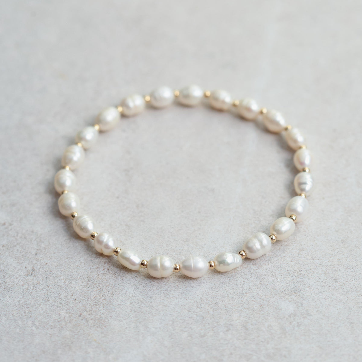 Soft Radiance Pearl bracelet with 14K gold accents by Earthly Abundance, featuring lustrous pearls on a delicate jewelry chain.