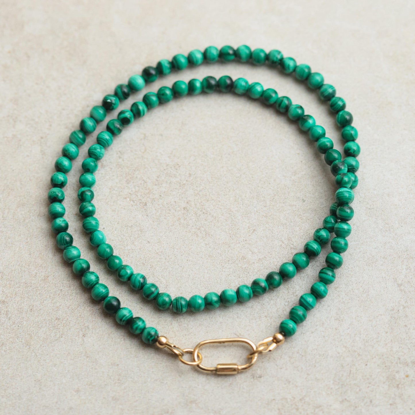 Malachite 4mm carabiner from Earthly Abundance Jewelry featuring polished green malachite stone with silver-tone clasp.