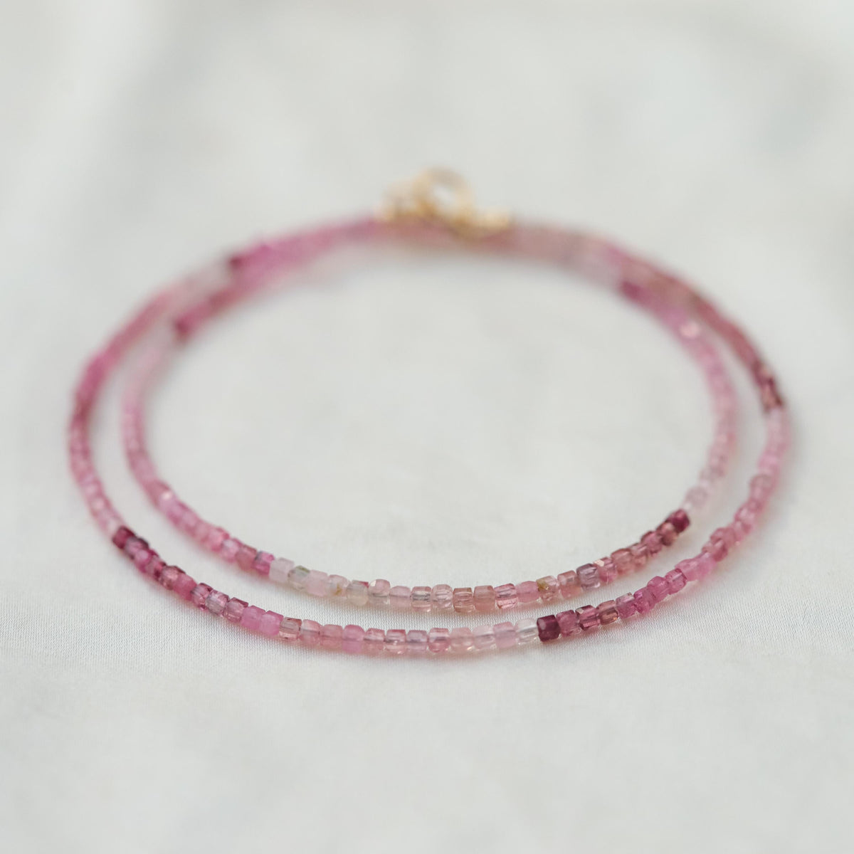 Pink Tourmaline cube necklace by Earthly Abundance featuring a faceted pink tourmaline gemstone pendant on a delicate chain.