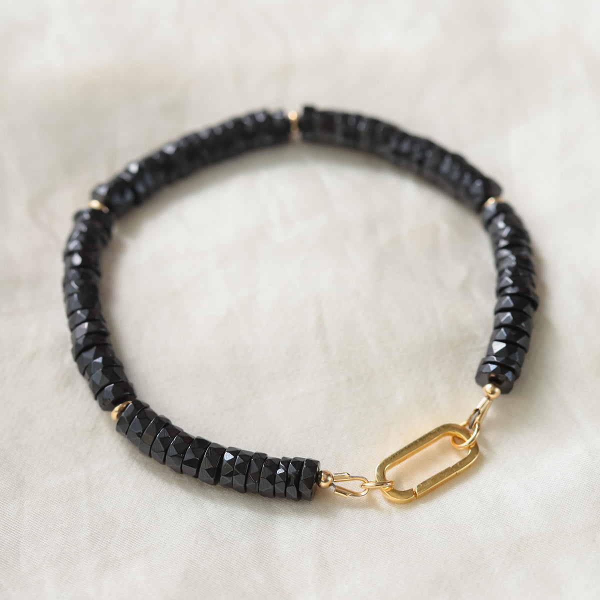 Black Spinel Carabiner Bracelet from Earthly Abundance Jewelry featuring black spinel beads and a silver-tone carabiner clasp.