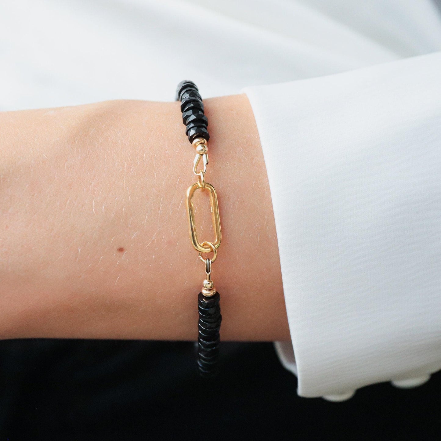 Black Spinel Carabiner Bracelet by Earthly Abundance Jewelry featuring black spinel stones on a metal carabiner clasp.
