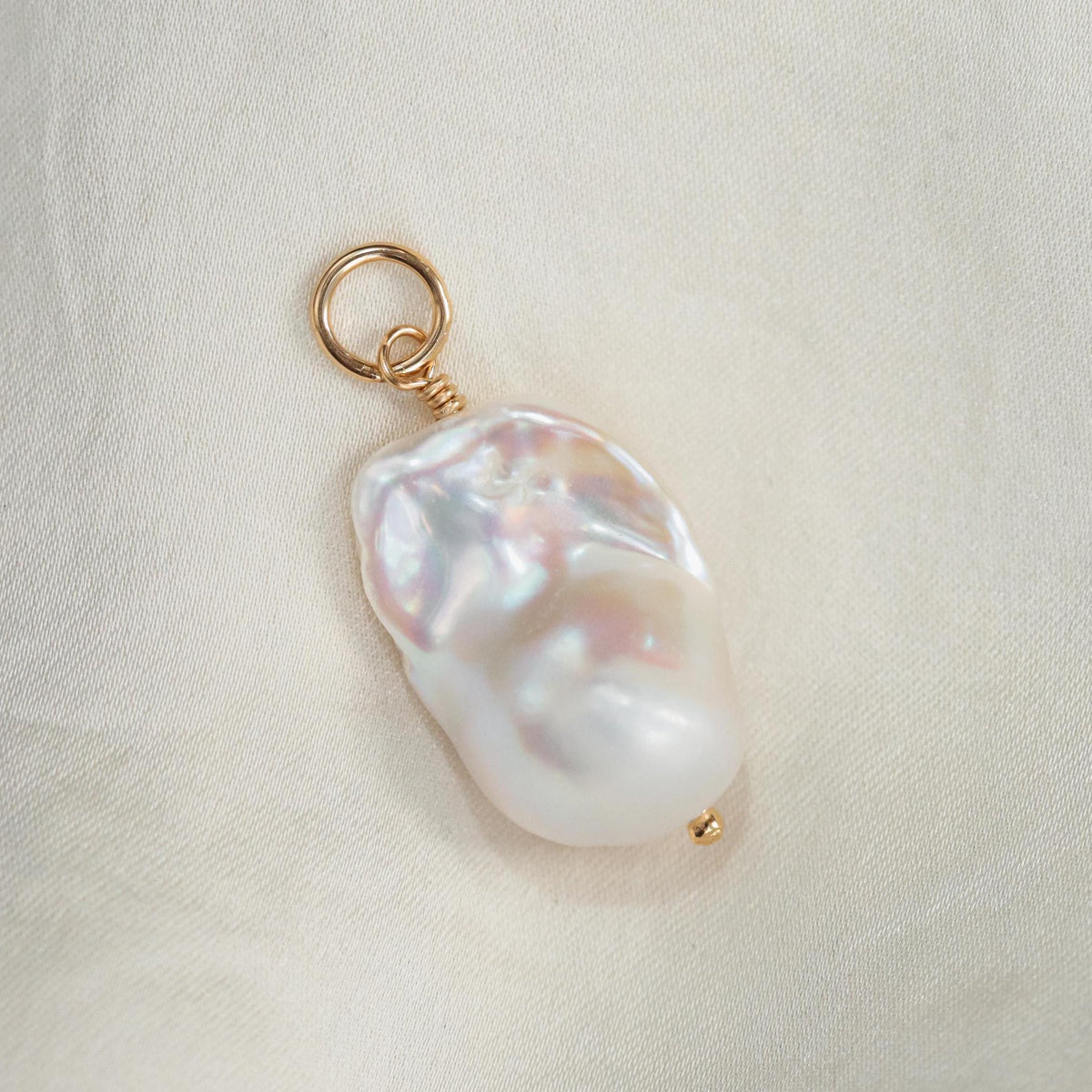 Aphrodite Baroque Pearl Pendant from Earthly Abundance featuring a large, irregular freshwater pearl on a delicate chain.