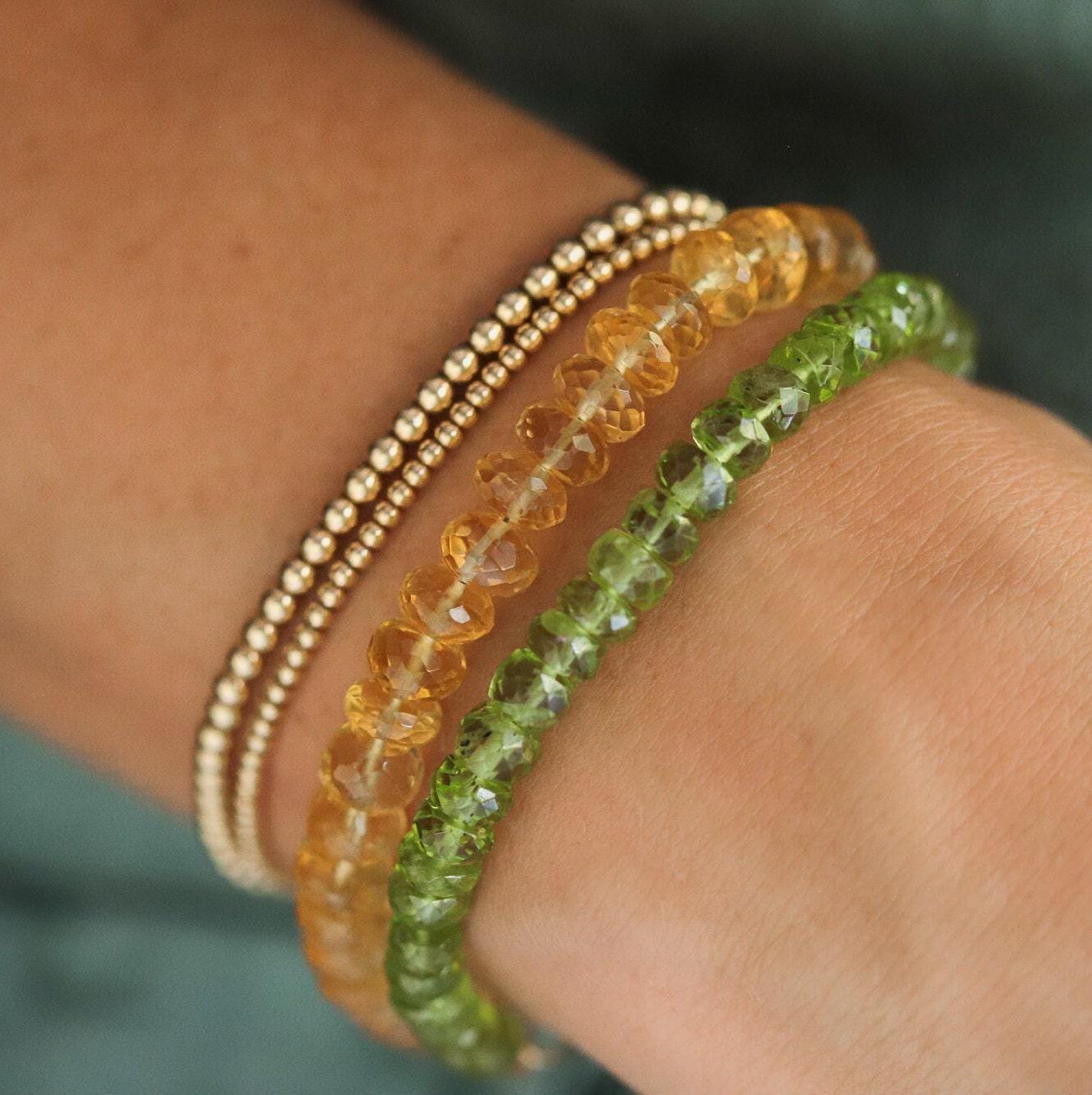 Faceted peridot rondel bracelet by Earthly Abundance, featuring vibrant green gemstones on a delicate silver chain.