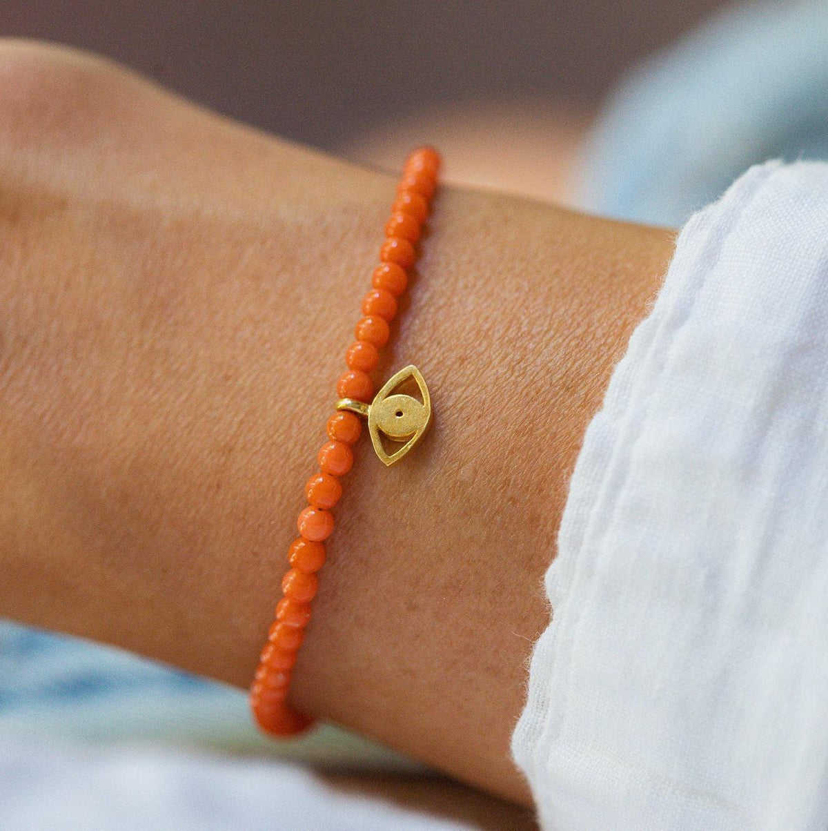 Italian Coral with Evil Eye jewelry piece from Earthly Abundance featuring vibrant coral and protective evil eye charm.