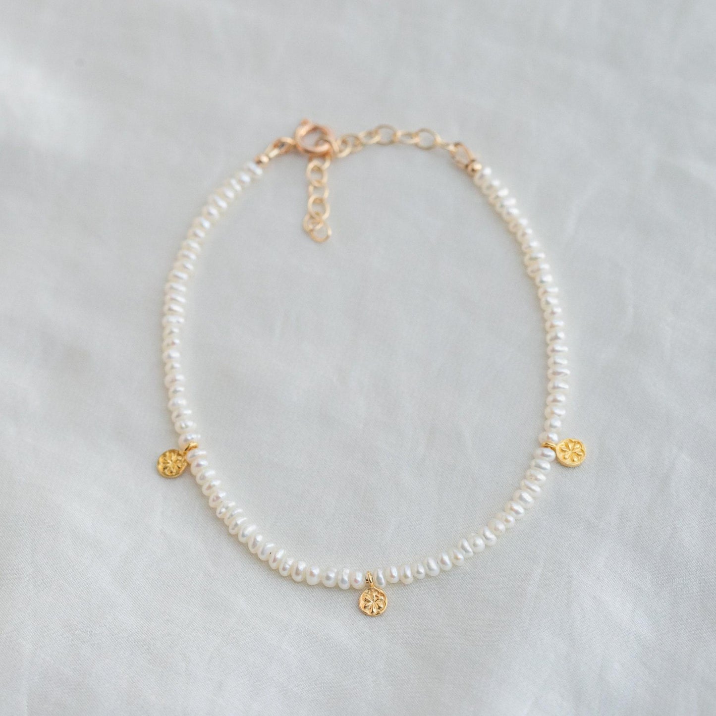 Fresh water pearl daisy anklet by Earthly Abundance featuring delicate pearl and floral charm design on a silver chain.