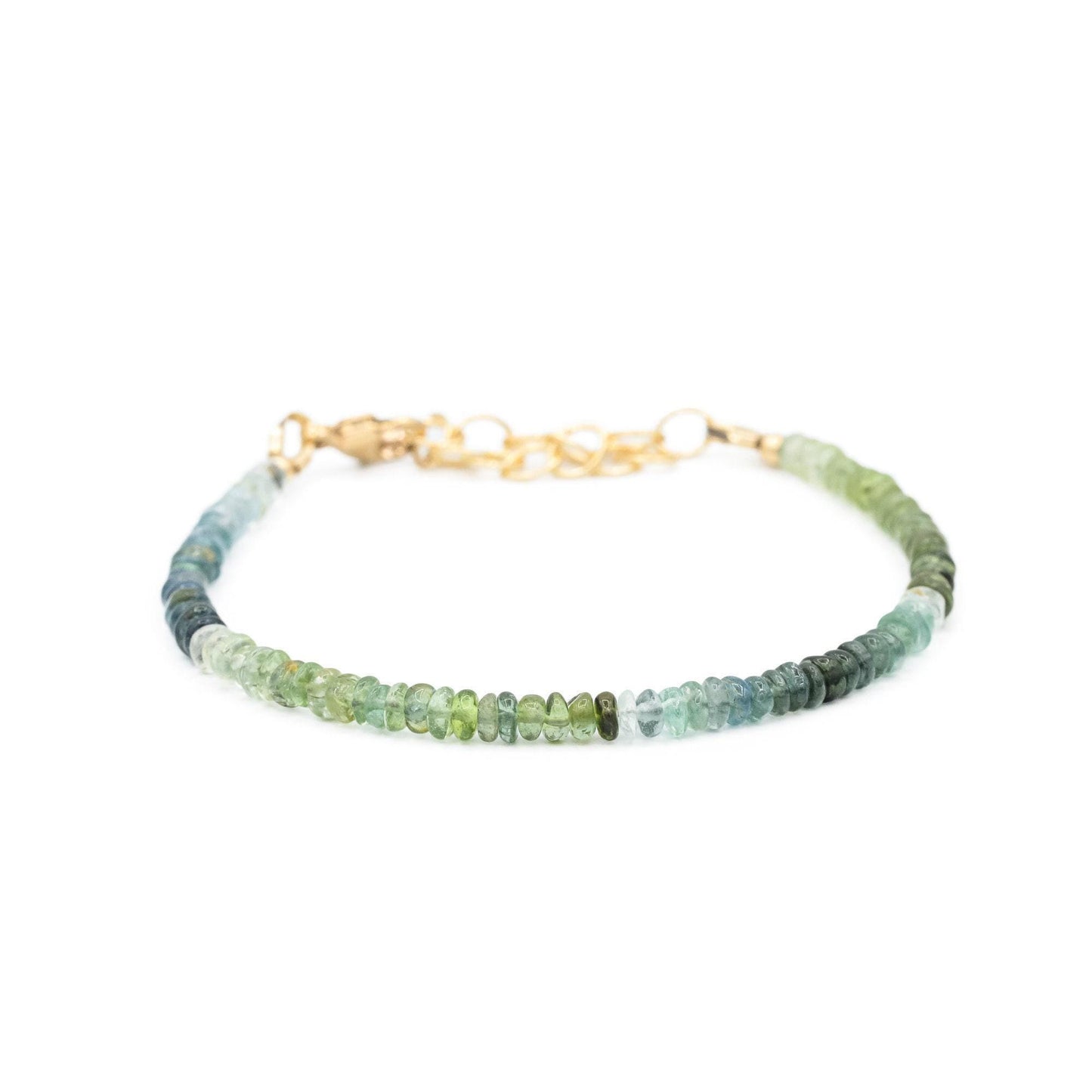 Green and blue tourmaline gemstone from Earthly Abundance Jewelry, showcasing vibrant colors and polished, faceted surface.