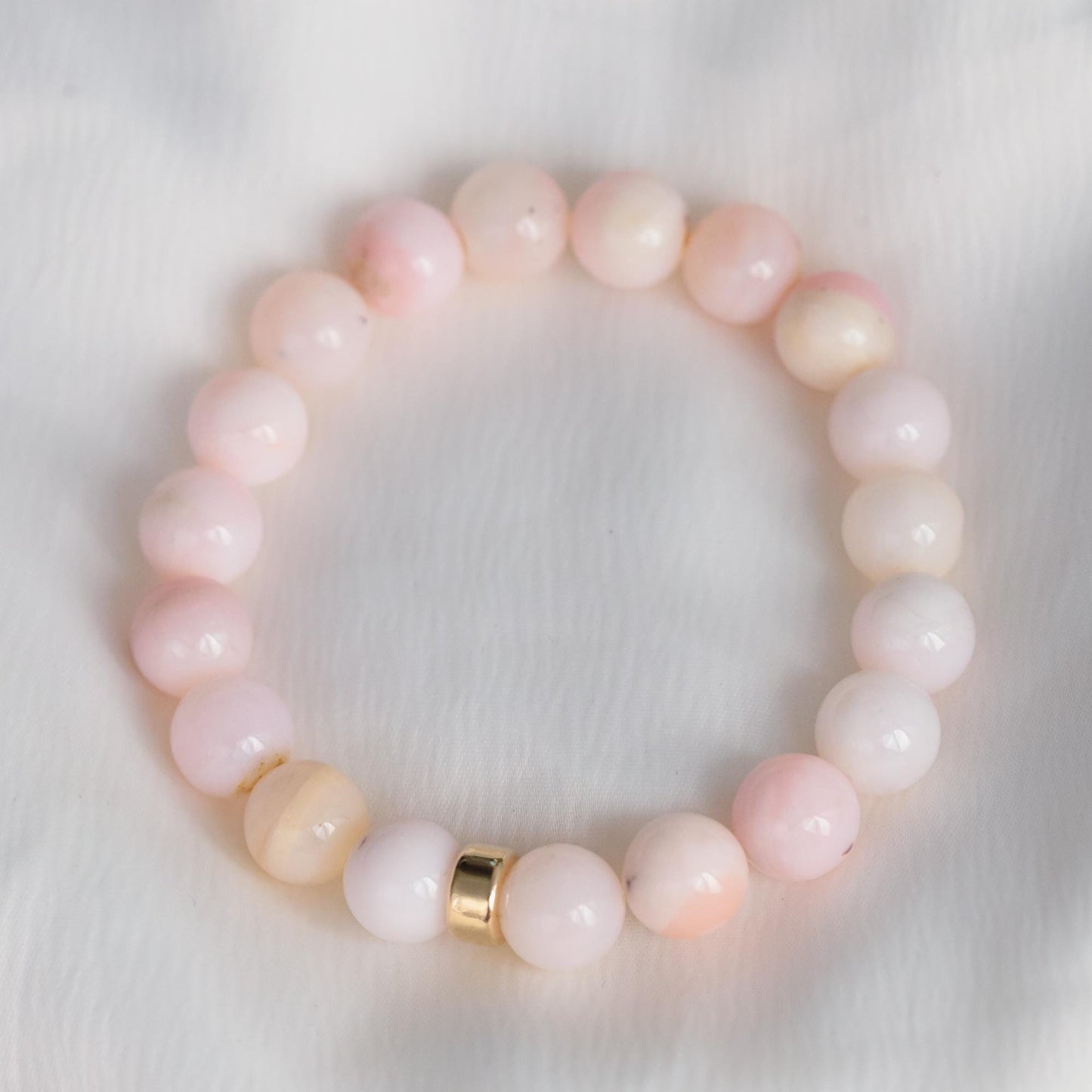 Bold pink opal bracelet with 14K gold accents from Earthly Abundance, featuring polished pink opal beads and elegant gold details.