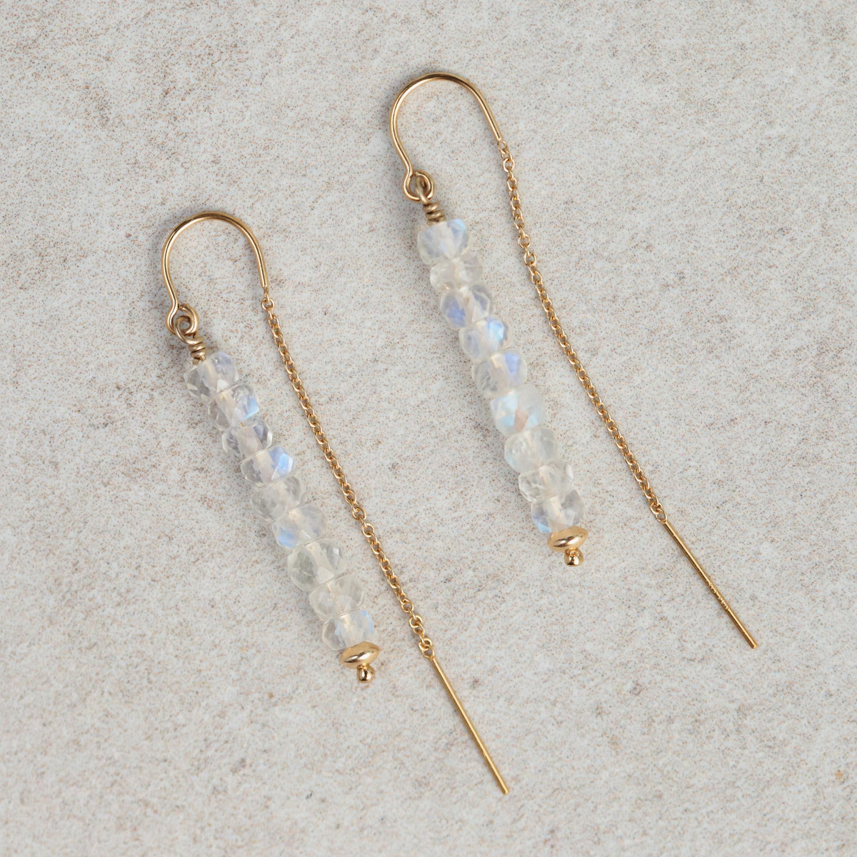 Moonstone threader earrings by Earthly Abundance featuring delicate silver chains and shimmering moonstone stones.