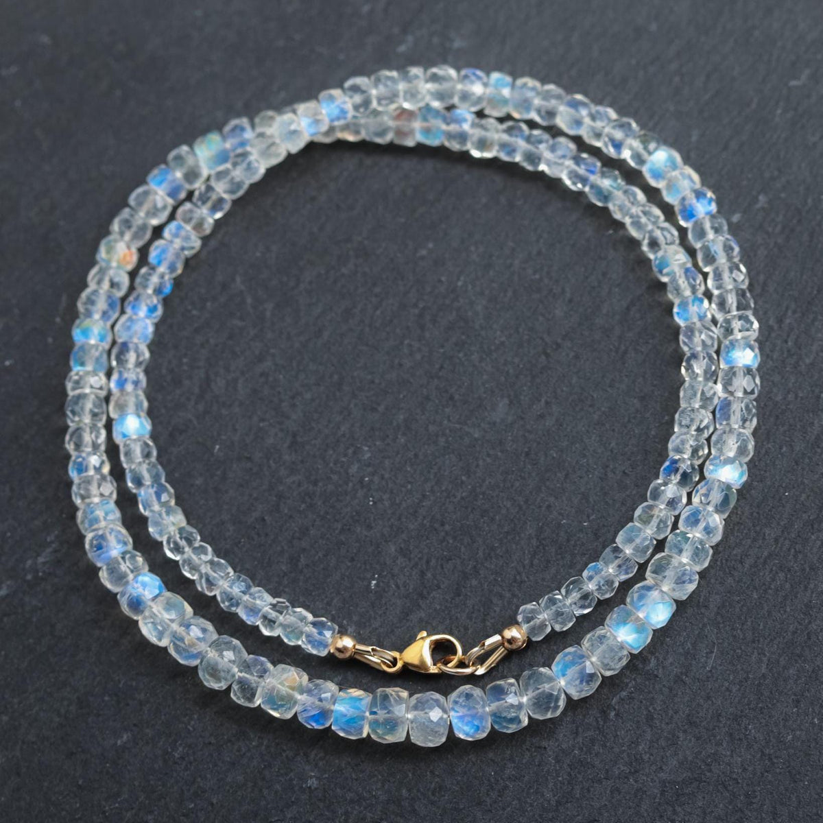 Moonspell Moonstone Necklace by Earthly Abundance featuring a shimmering moonstone pendant on a silver chain.