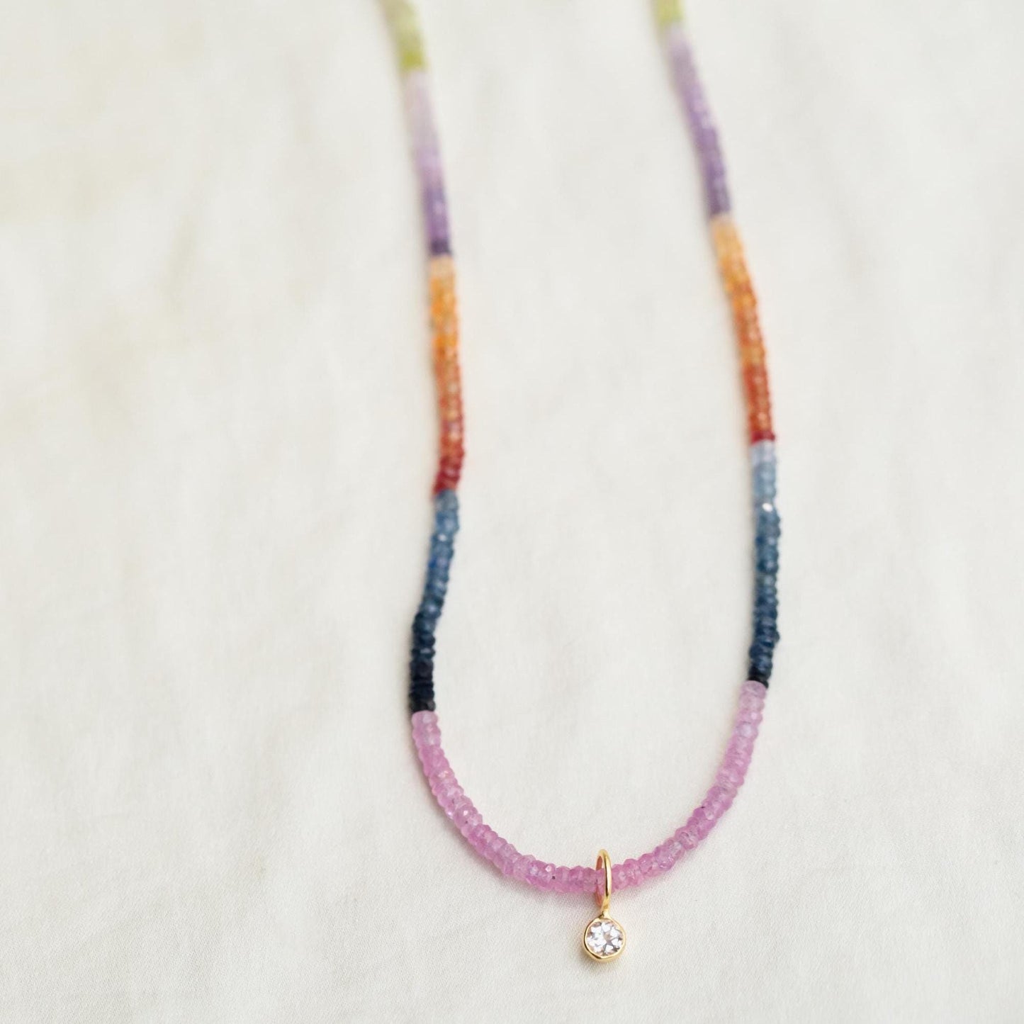 Multi sapphire necklace by Earthly Abundance featuring vibrant blue and pink sapphires on a delicate chain.