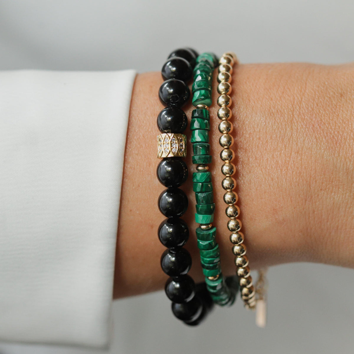 Malachite manifestation bracelet with 14K gold-filled beads, featuring vibrant green stones on a delicate jewelry strand.