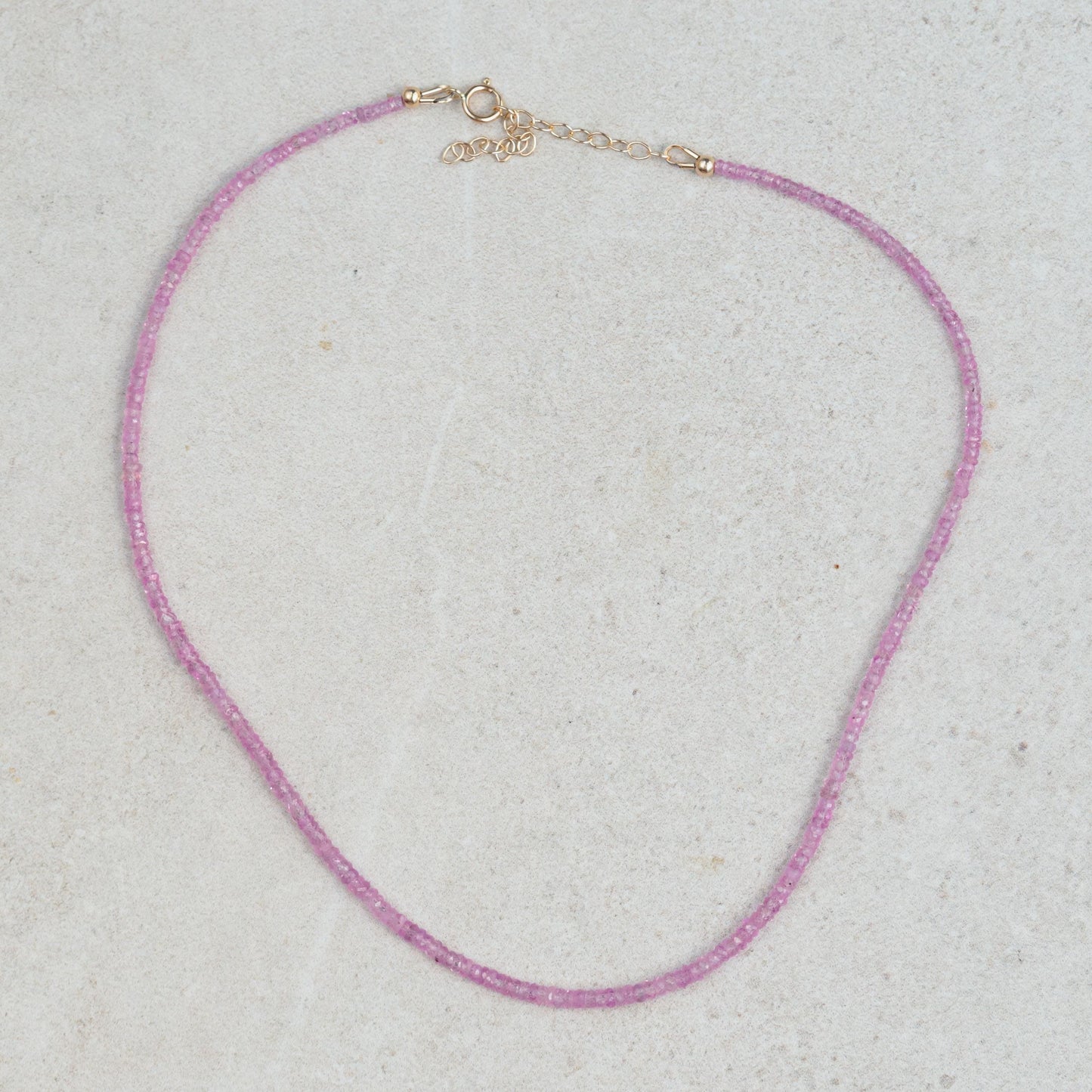 Pink sapphire necklace featuring a delicate chain and vibrant pink sapphires from Earthly Abundance.