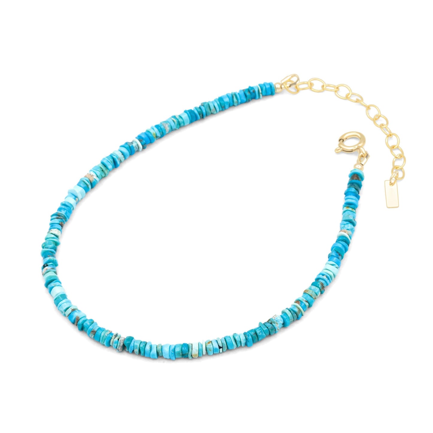 Earthly Abundance turquoise Heishi anklet with earthy textured beads and silver accents, styled on a model's ankle.