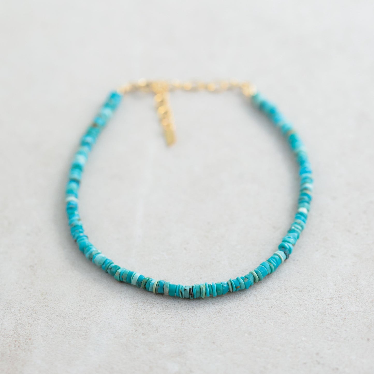 Earthy Texture Turquoise Heishi Anklet from Earthly Abundance featuring small turquoise beads and earthy-toned accents on a delicate chain.