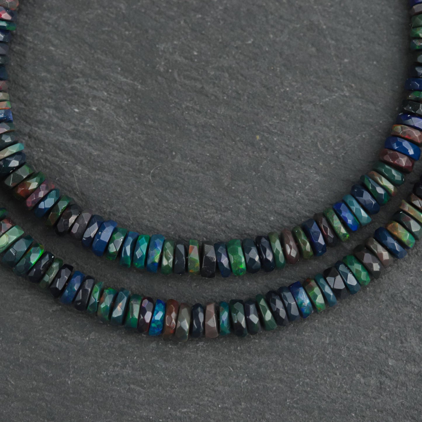 Black Ethiopian Opal beaded necklace featuring vibrant, polished stones on a delicate string, crafted by Earthly Abundance.
