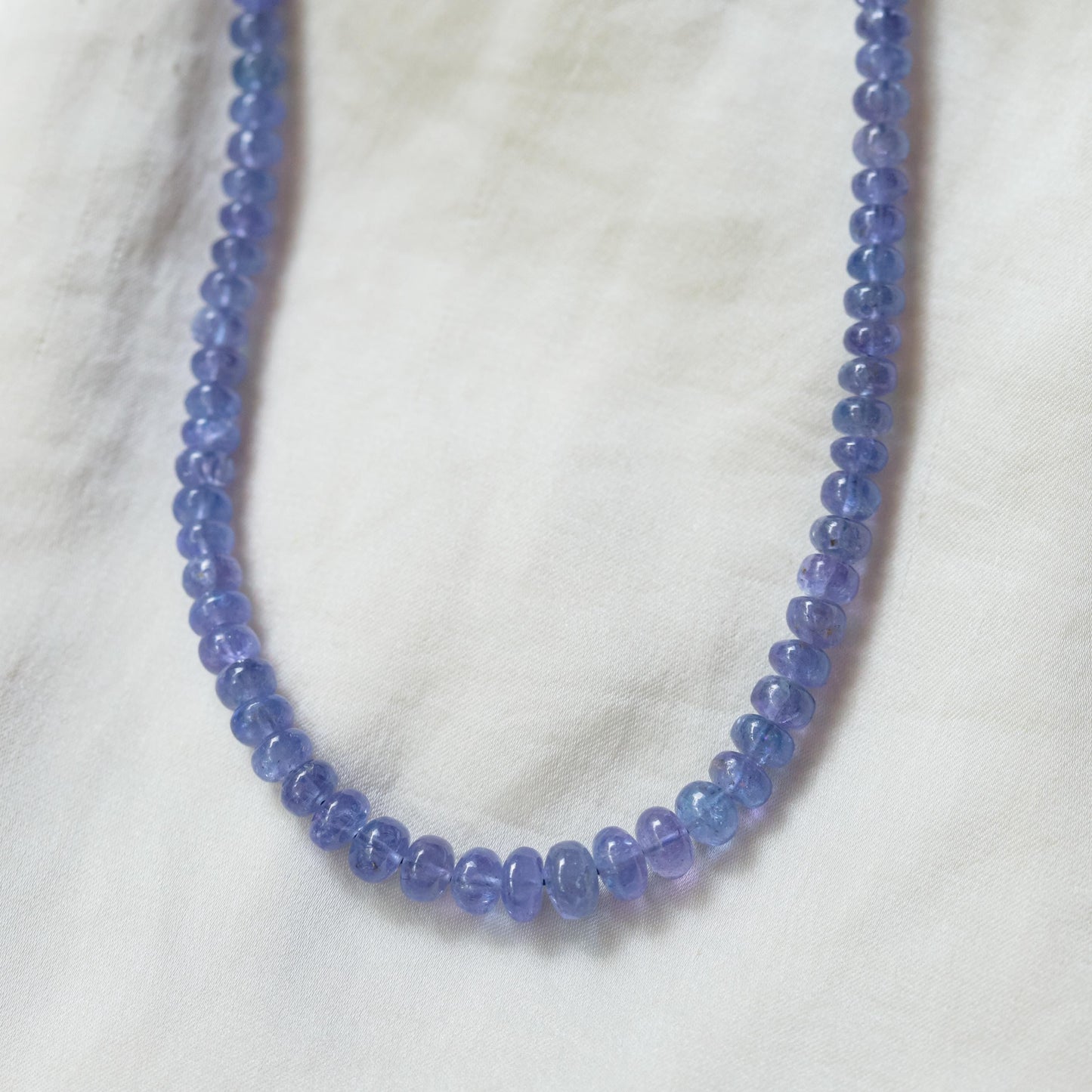 Tanzanite smooth rondel necklace in 14K gold with alternating blue-purple tanzanite beads, elegant and sparkling jewelry piece
