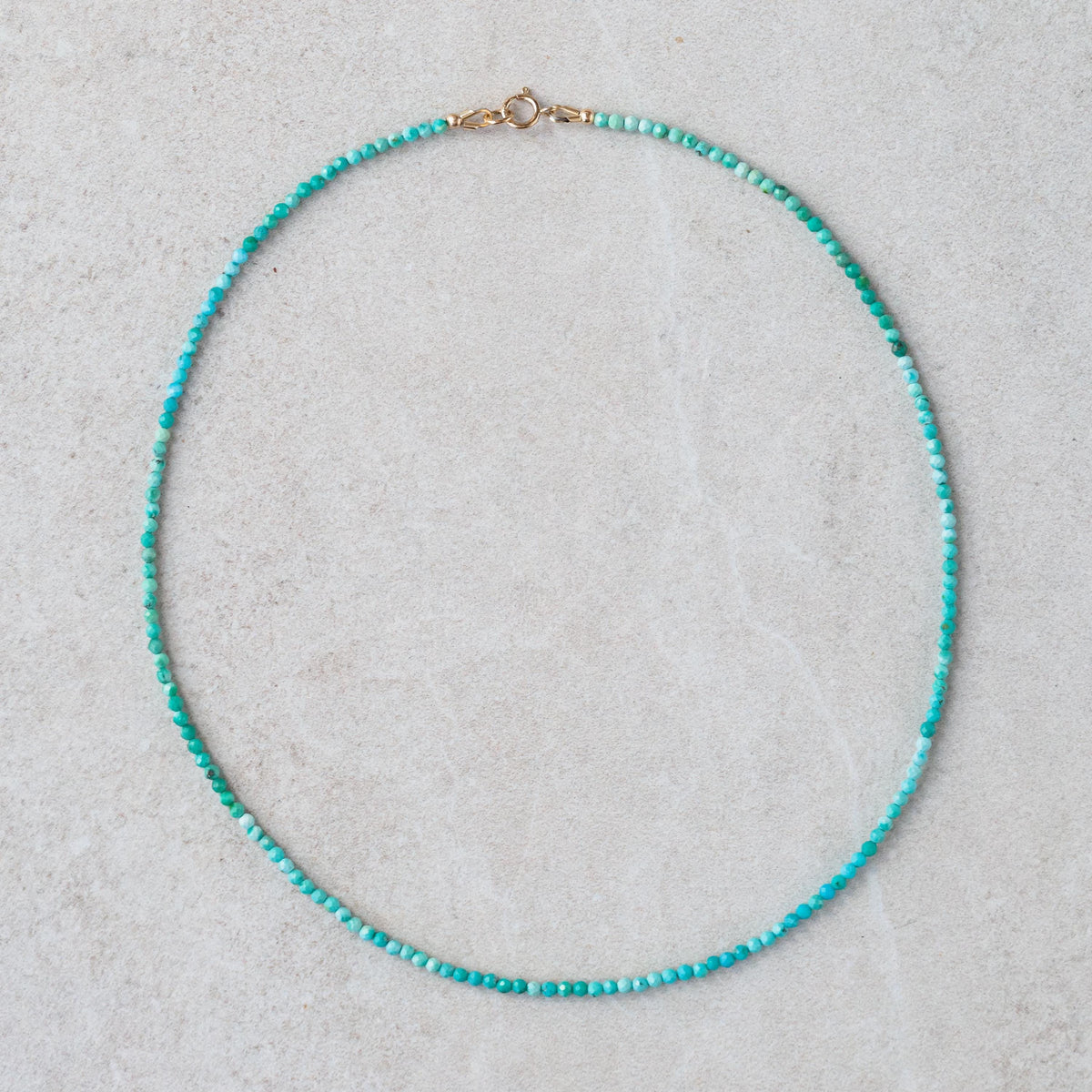 Turquoise 14K gold necklace from Earthly Abundance Jewelry featuring a vibrant turquoise pendant on a delicate chain