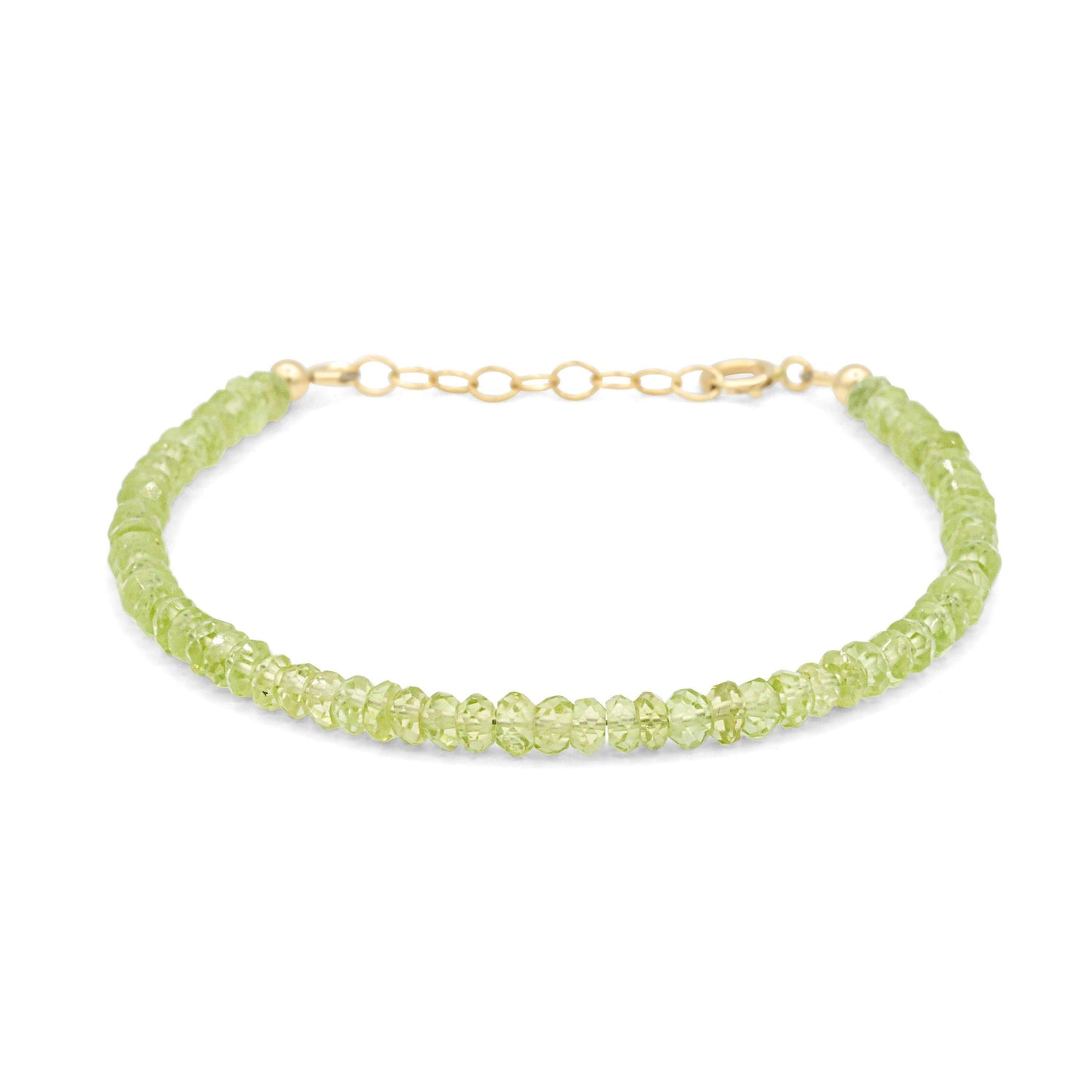 Peridot stacking bracelet by Earthly Abundance featuring multiple green peridot gemstone beads on a delicate silver chain.