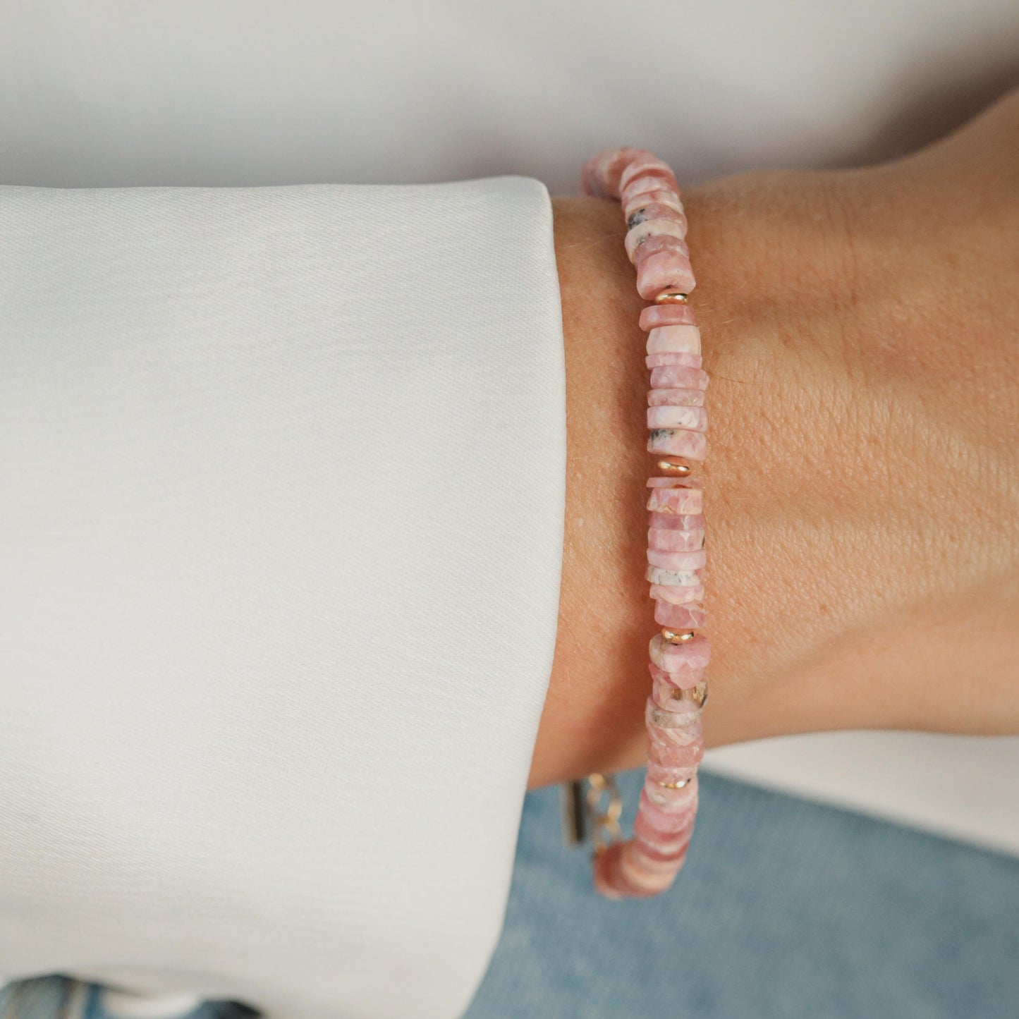 Renewal Rhodochrosite bracelet by Earthly Abundance featuring polished pink and red rhodochrosite beads on an elastic band.