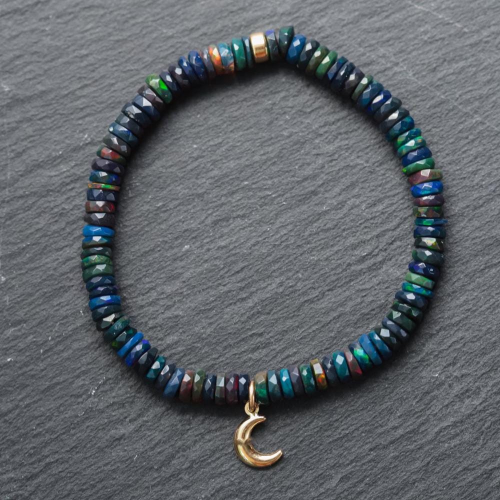 Black Opal Moon bracelet with 14K gold setting from Earthly Abundance, featuring a moon-shaped black opal gemstone.