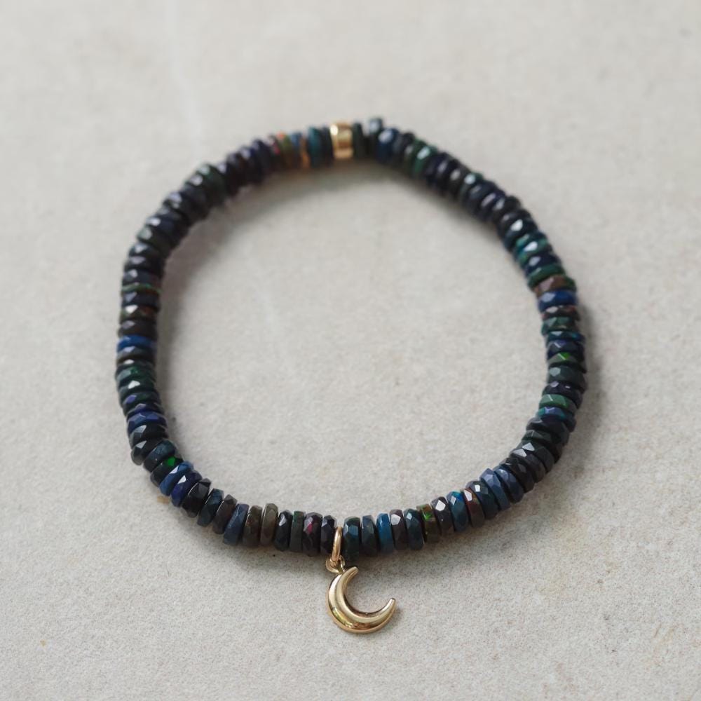 Black Opal Moon bracelet with 14K gold setting, featuring a polished moon-shaped black opal gemstone, from Earthly Abundance.