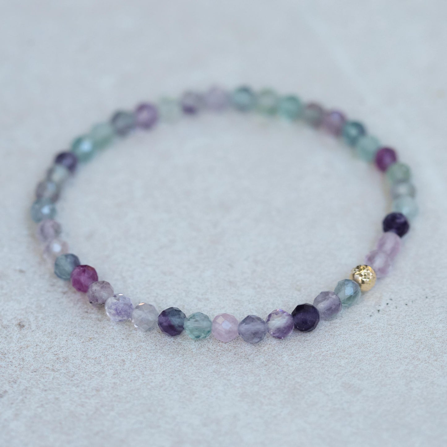 Rainbow Fluorite bracelet from Earthly Abundance featuring vibrant multicolored fluorite stones on a stretchy band.