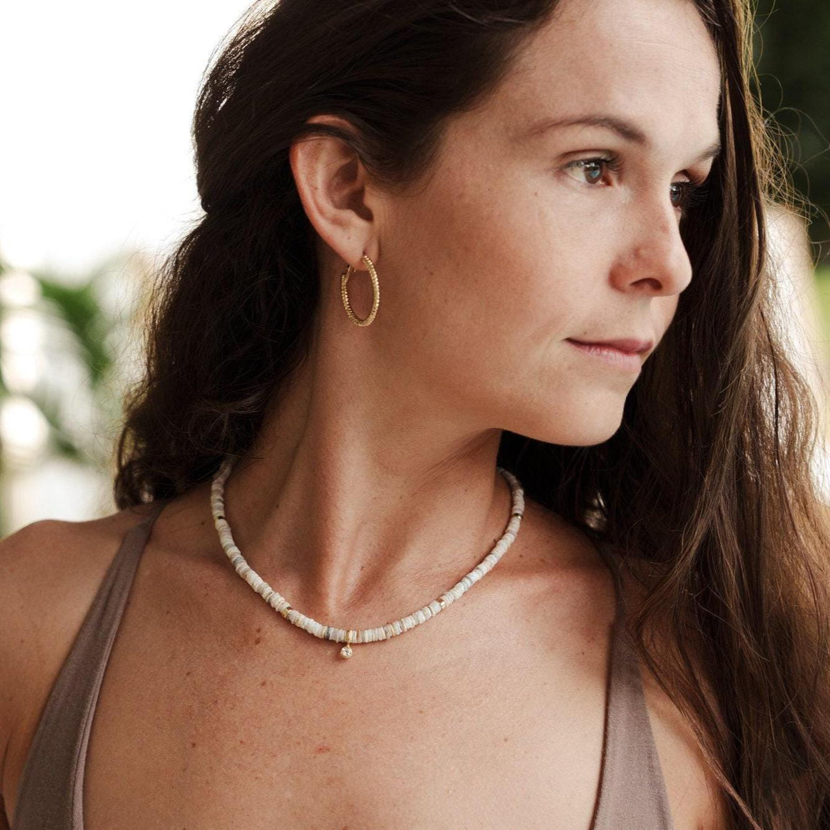 Australian opal and white topaz necklace featuring a delicate pendant with sparkling gemstones on a silver chain.