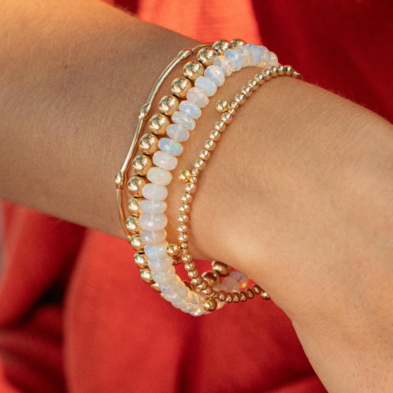 Soft fire opal bracelet in 14K gold featuring vibrant, glowing fire opal stones on a delicate gold chain.