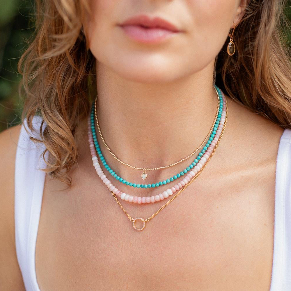 Pink Opal necklace with softly radiant stones from Earthly Abundance, showcasing a delicate, elegant jewelry piece on a white background.