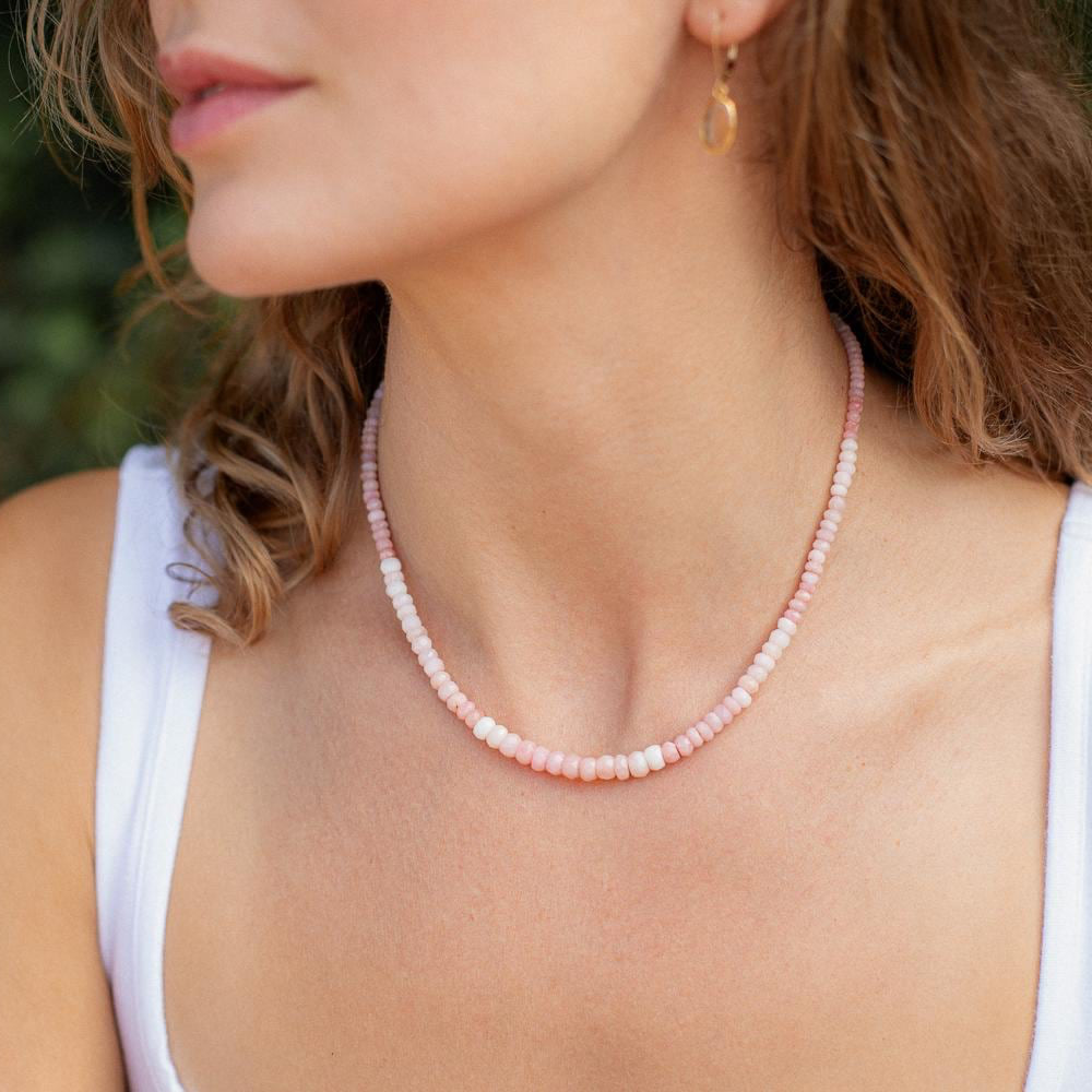 Pink Opal necklace featuring softly radiant stones, crafted by Earthly Abundance, displayed on a neutral background.