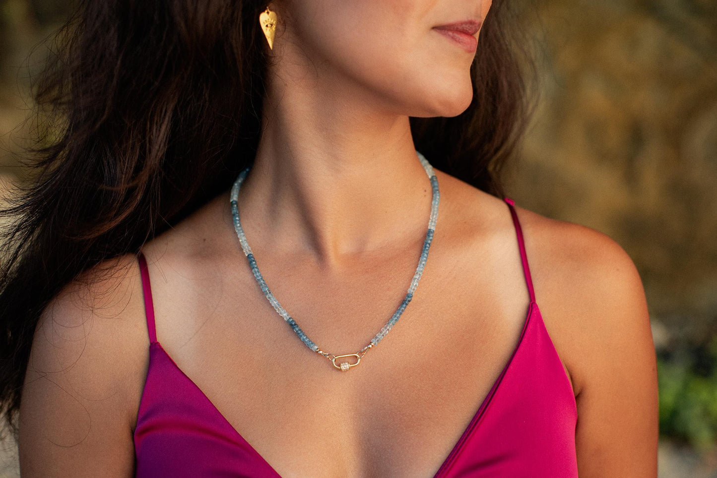 Earthly Abundance Santa Maria Topaz necklace featuring a large, faceted topaz gemstone pendant on a silver chain.