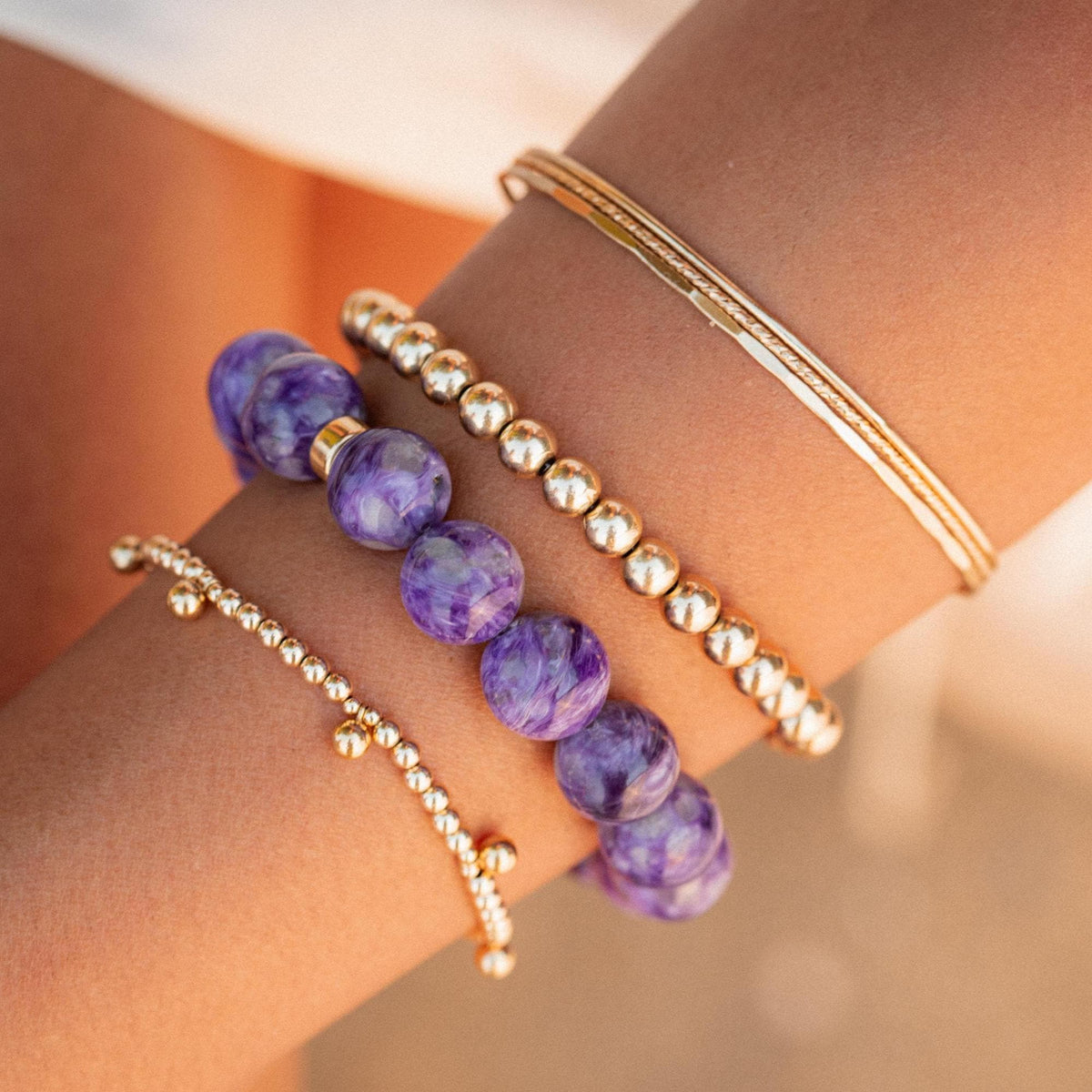 AAA+ grade 12mm Charoite gemstone bead from Earthly Abundance, showing vibrant purple and swirling natural patterns.