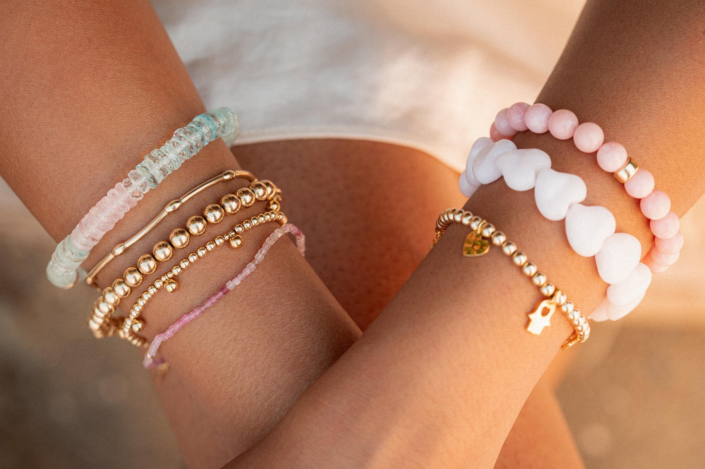Elegant sweetheart bracelet featuring Morganite, Aquamarine, and White Topaz gemstones on a delicate gold chain.
