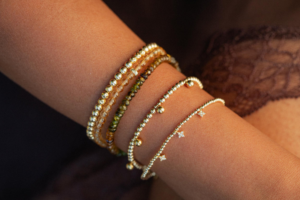 Earthly Abundance Petro Tourmaline Bracelet featuring polished gemstone beads on an elastic band, close-up view of the jewelry.