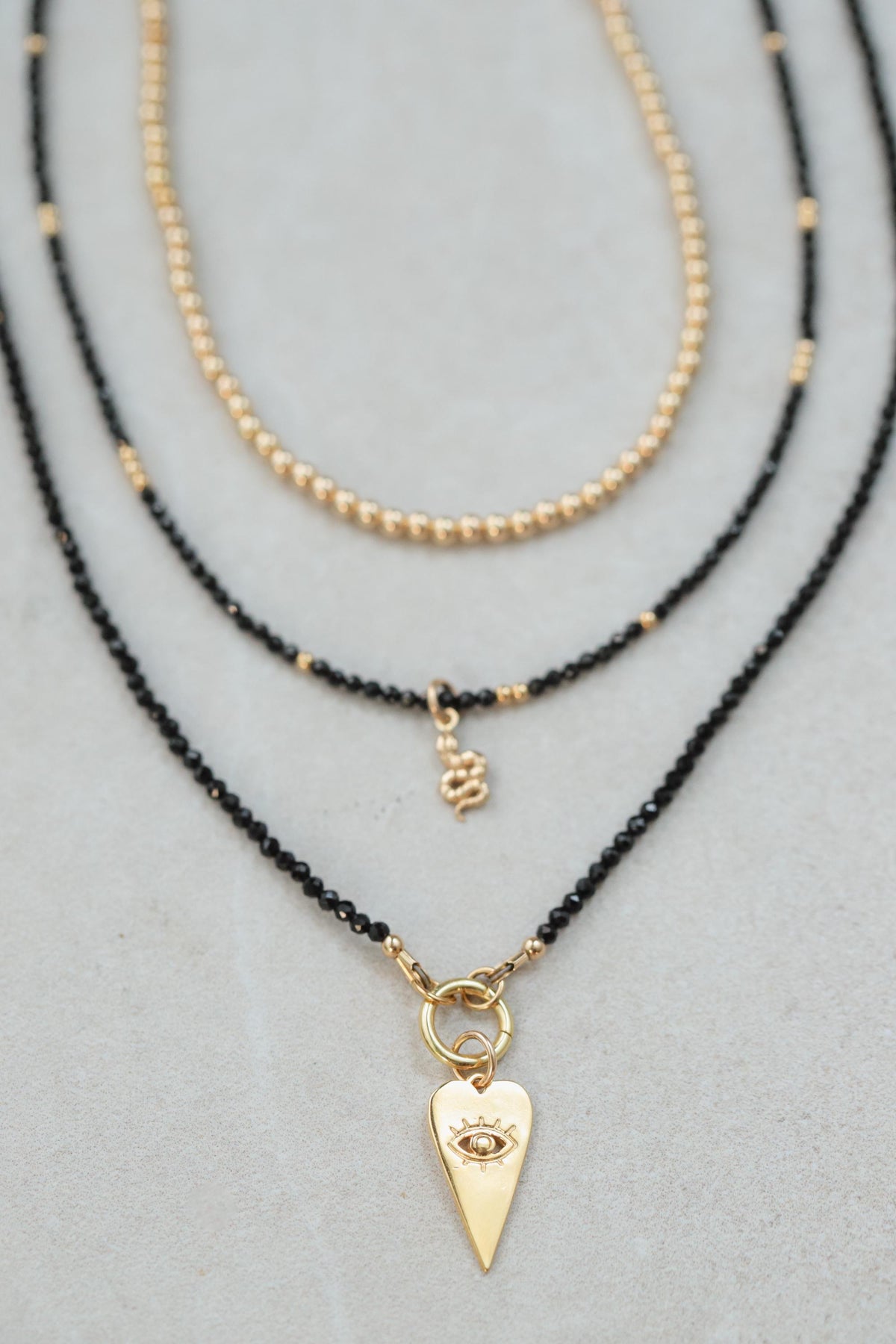 Black Spinel Evil Eye Necklace by Earthly Abundance featuring a dark, protective gemstone pendant on a delicate chain.