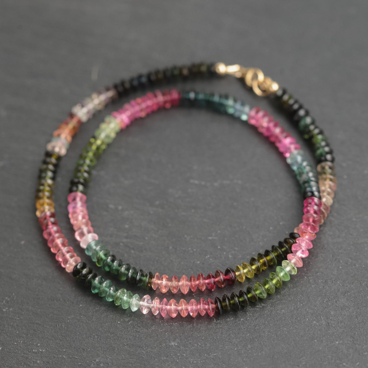 Mixed tourmaline gemstone beaded necklace by Earthly Abundance featuring colorful round beads on a delicate chain.