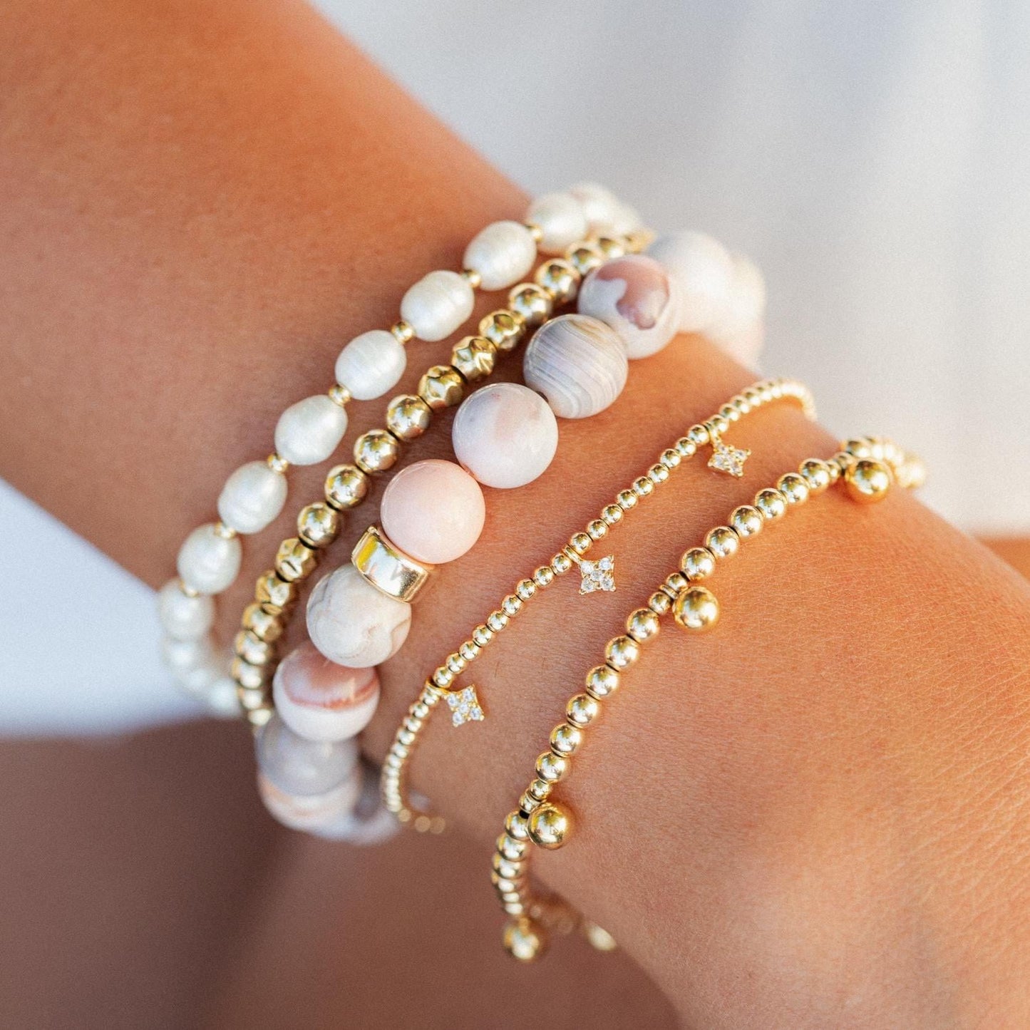 Pink Botswana Agate bracelet with polished beads from Earthly Abundance, showcasing its vibrant pink and natural stone texture.