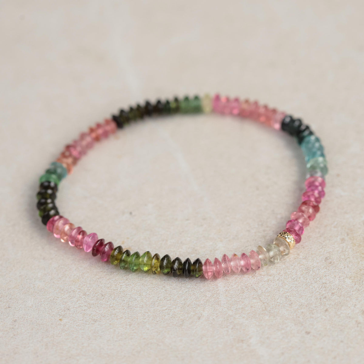 Mixed tourmaline smooth rondel bracelet with 14K gold accents from Earthly Abundance, featuring colorful polished gemstone beads.