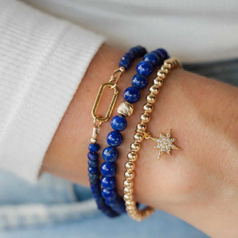 Lapis Lazuli carabiner bracelet by Earthly Abundance featuring deep blue stones and a sturdy metal carabiner clasp.