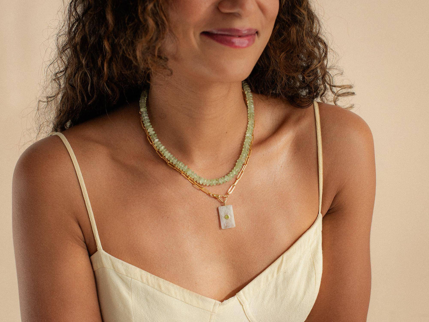 Prehnite necklace with 14K gold chain from Earthly Abundance, featuring a smooth, oval-shaped green gemstone pendant.