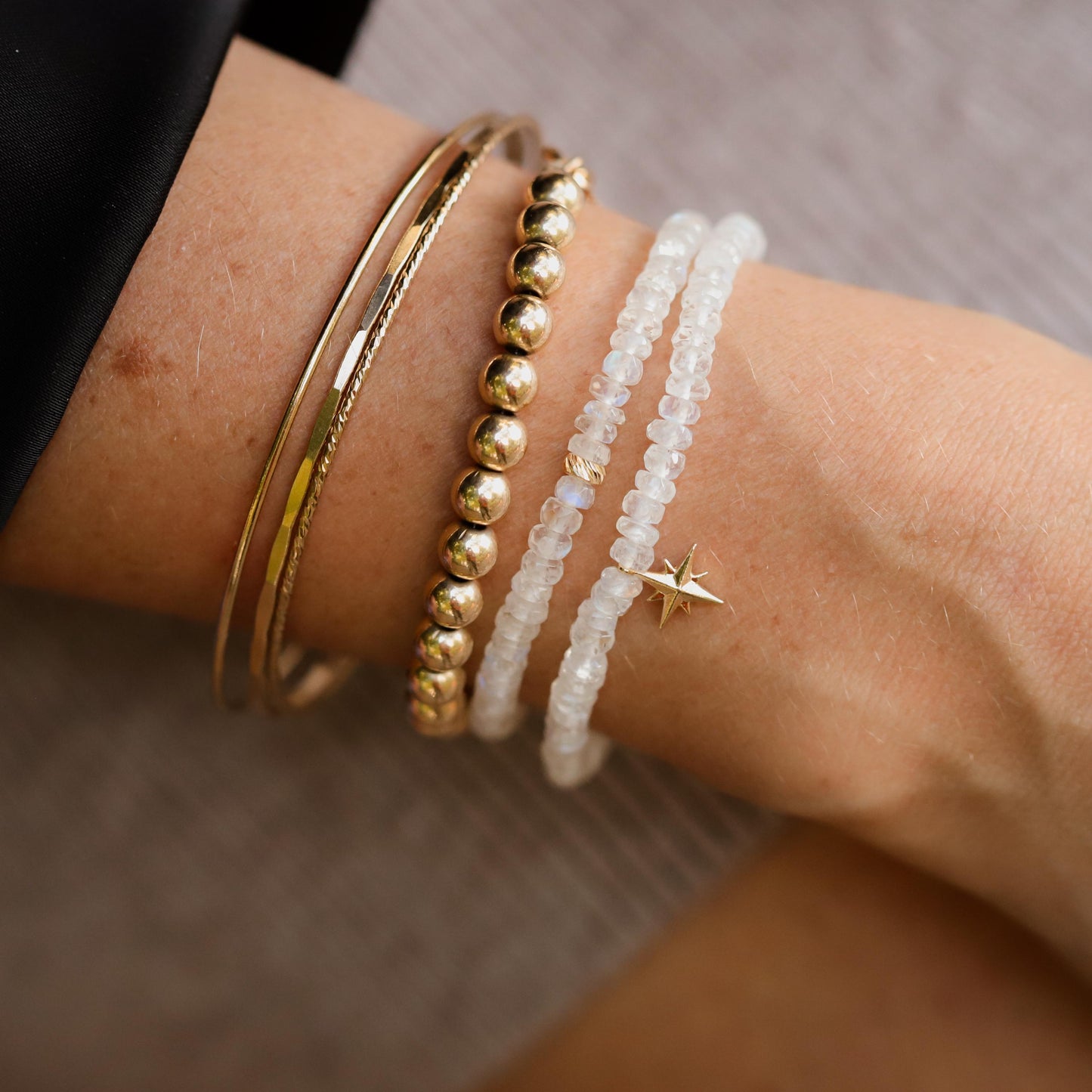 Rainbow moonstone bracelet with 14K gold accents from Earthly Abundance, featuring smooth, polished moonstone beads on a delicate chain.