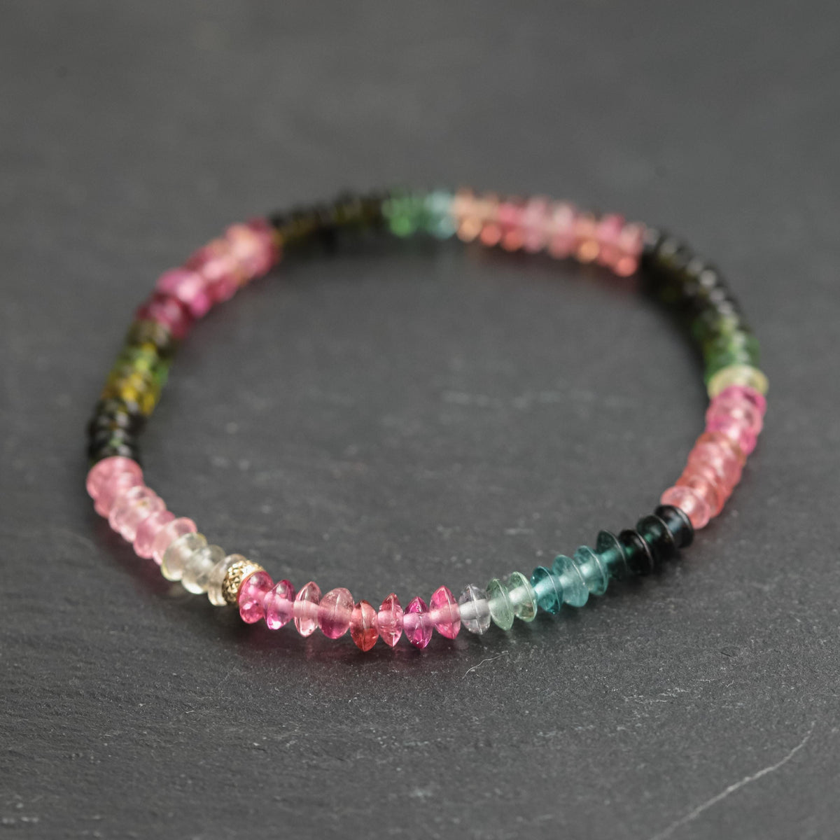 Mixed tourmaline smooth rondel bracelet with 14K gold clasp from Earthly Abundance, showcasing colorful gemstone beads.