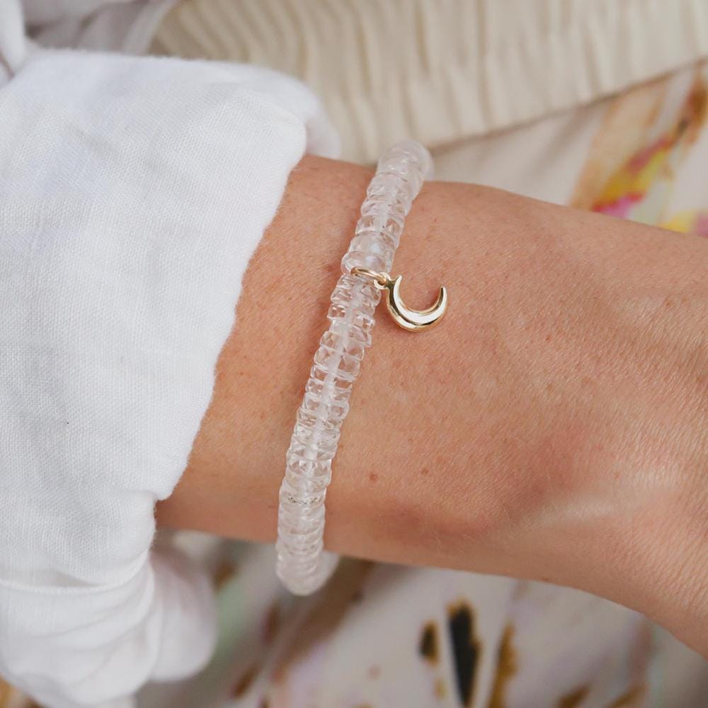 Clear quartz Heishi moon bracelet with 14K gold accents from Earthly Abundance, featuring smooth round beads and moon-shaped charms.