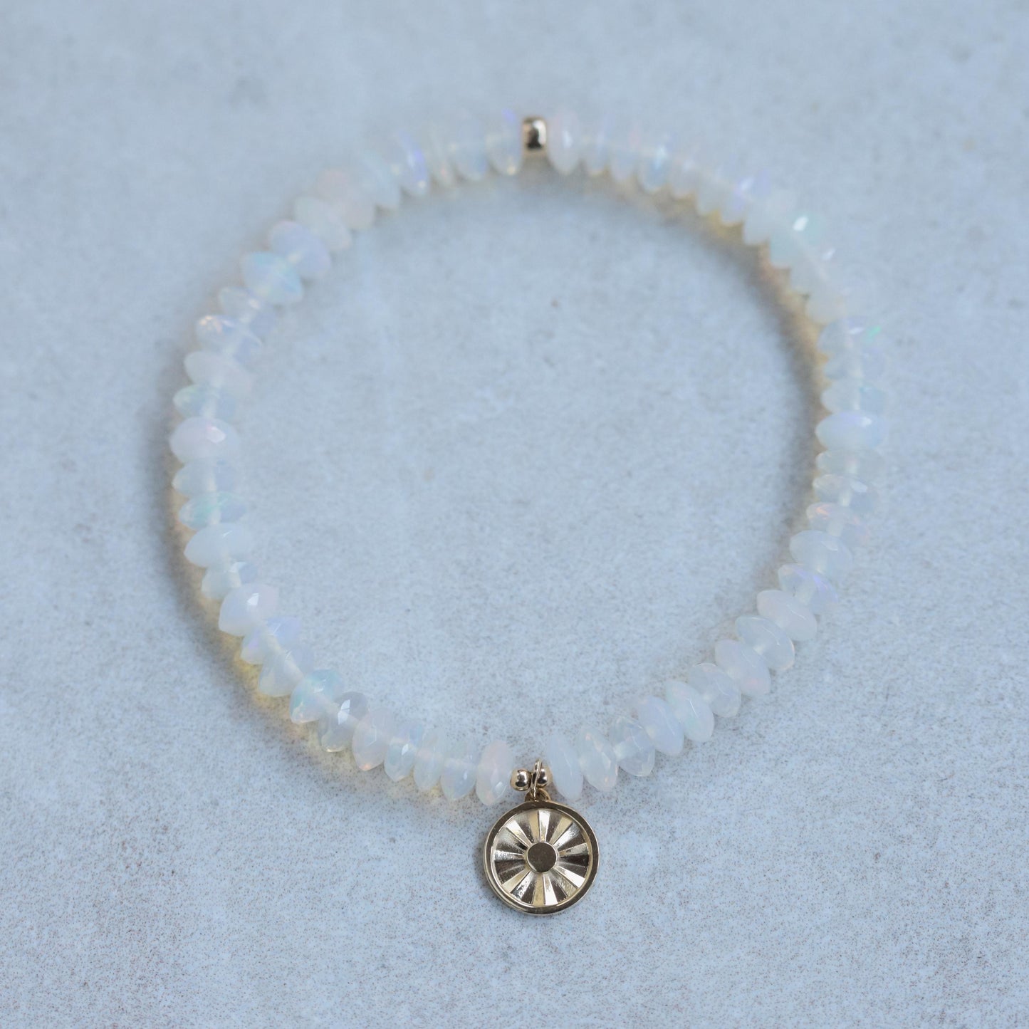Ethiopian Welo Opal sun bracelet with 14K gold setting, featuring a radiant opal gemstone on a delicate gold chain.