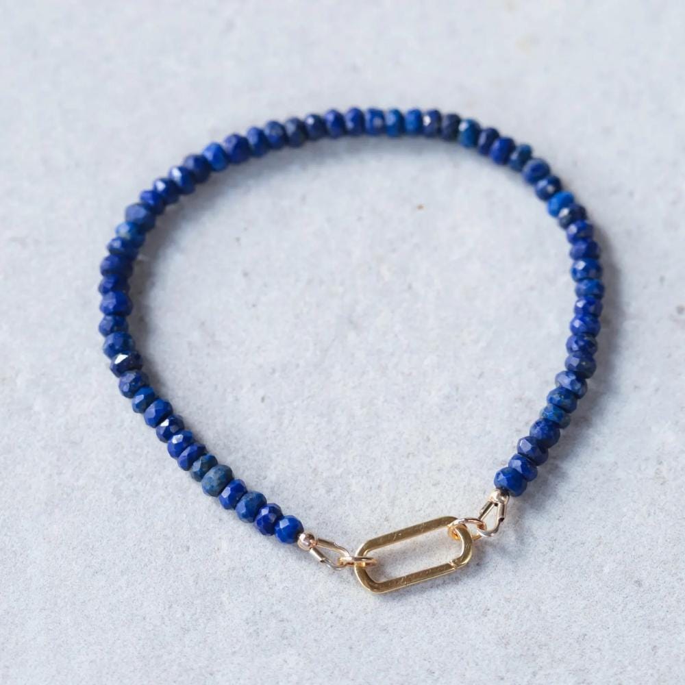 Lapis Lazuli carabiner bracelet by Earthly Abundance featuring deep blue stones and a silver-tone carabiner clasp.