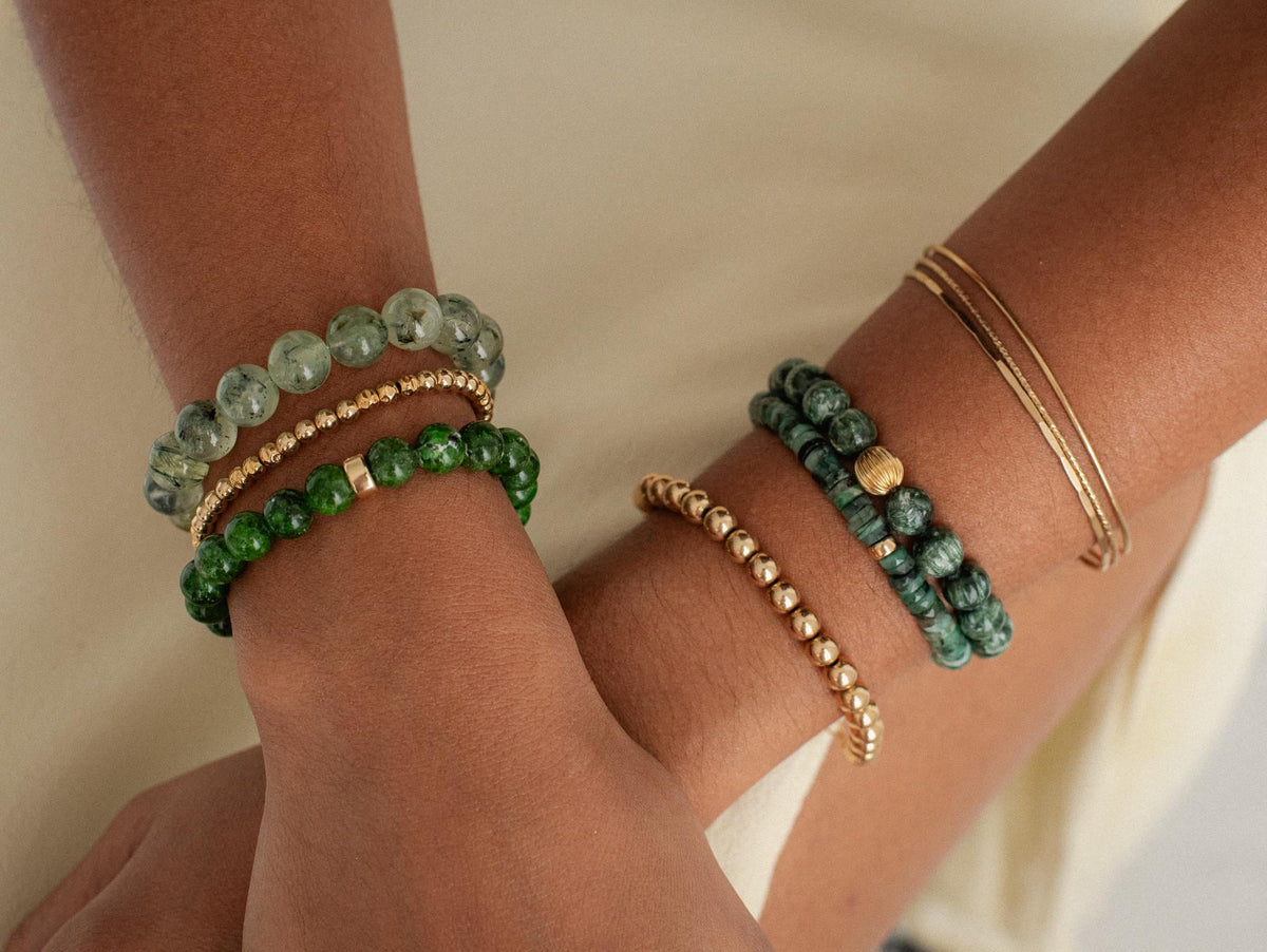 Emerald North Star Heishi bracelet by Earthly Abundance featuring 14K gold accents and small green gemstone beads.