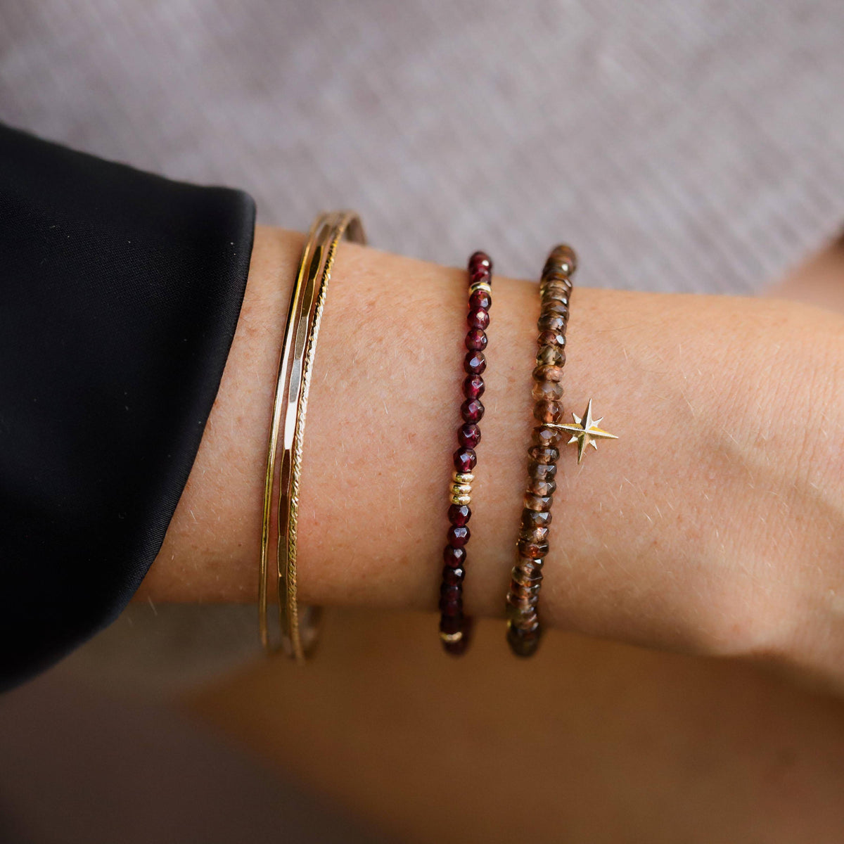 Earthly Abundance Jewelry garnet beaded bracelet with polished red gemstone beads and an adjustable silver clasp.