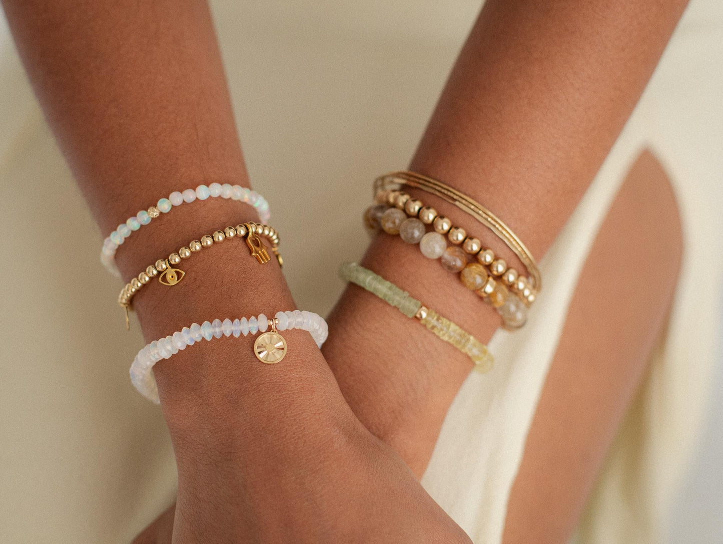 Ethiopian Welo Opal sun bracelet with 14K gold setting, featuring vibrant opal stones and intricate sunburst design.