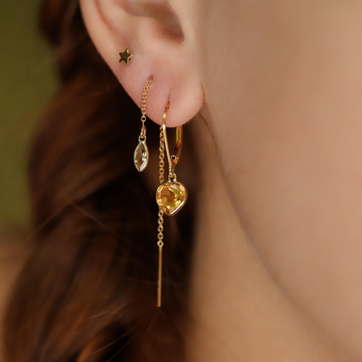 14K Citrine hearts earrings by Earthly Abundance featuring gold hooks and heart-shaped citrine gemstones.